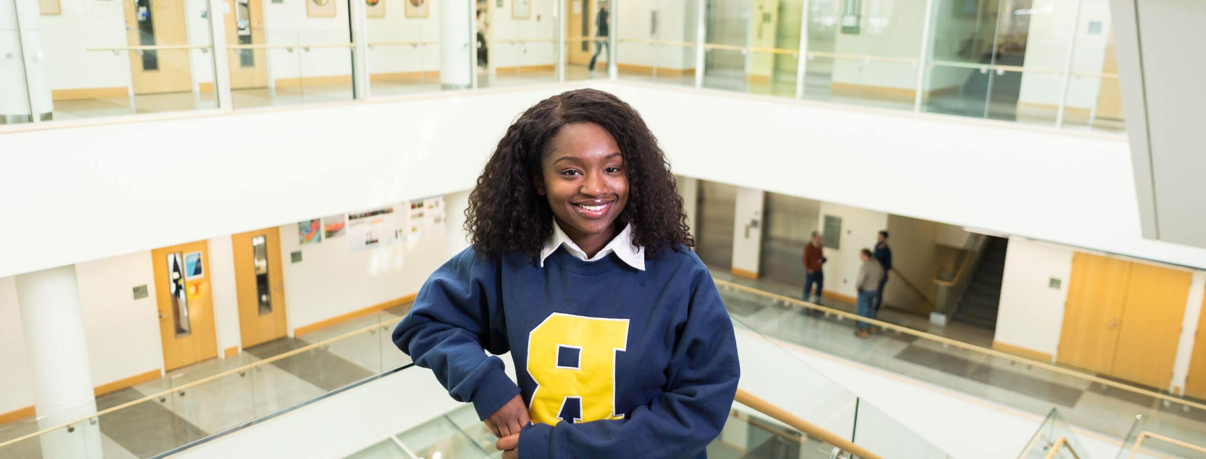 A University of Rochester Student studying at a cafe.